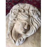 A garden stoneware cherub face wall mounted plaque