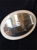 A white oval bevel edged mirror