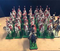 A large selection of hand painted lead figures of a mounted band members.