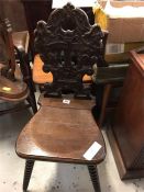 A Hall chair with Bobbin legs and carved back with musical theme