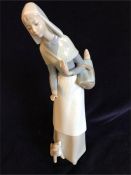 Lladro figure of a lady with bread basket and puppy