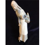 Lladro figure of a lady with bread basket and puppy