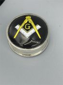 A silver pill box with masonic enamel image to the lid