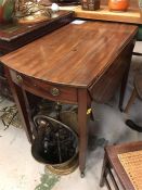 A small drop leaf table with drawer