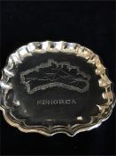 A silver ashtray with a map of Menorca