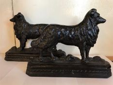 A pair of cast iron dog door stops