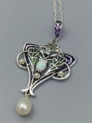 A Silver Art Nouveau style pendant necklace with opal and pearl drop on silver chain