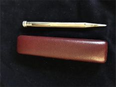 A silver pencil in a red case