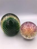 Two glass paperweights.