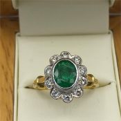 An 18ct yellow gold Emerald and Diamond Daisy style ring