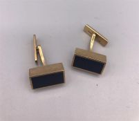 A pair of 9ct gold cuff links with onyx insets Total weight 13.3g