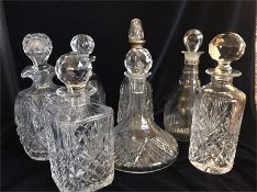 An Assortment of decanters, one with a silver neck