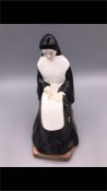 A Coalport figure of a praying nun