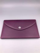 An Asprey 167 Button Organiser wallet, silk lined and in purple calf leather.