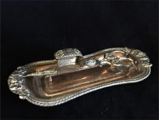 A silver plated candle snuffer with tray.