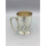A silver Christening mug, hallmarked Birmingham, reeded (107g)