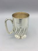 A silver Christening mug, hallmarked Birmingham, reeded (107g)