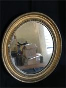 Small ornate oval gilt framed mirror