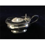 A silver mustard pot with blue glass liner