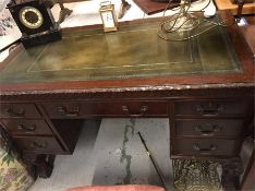 A Leather topped mahogany desk with ball and claw feet