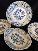 Three Meissen plates and a bowl in blue and white with pierced edging.