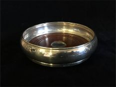 A silver wine coaster