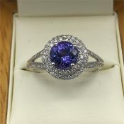 An 18ct white gold Tanzanite and Diamond halo style ring of 1.6ct's