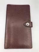 An Asprey Mens 167 Button Coat Wallet in Burgundy mini lettering in calf leather (10 x 18cm)