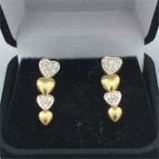 A Pair of 14ct yellow gold and Diamond graduated heart shaped earrings