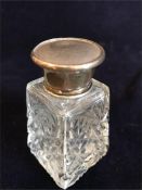 A hallmarked silver topped bottle