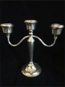 A silver three prong candlestick by ATC, hallmarked Birmingham