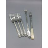 Hallmarked silver to include three cake forks, a pickle fork and a pickle fork with a mother of