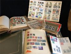 A selection of stamp albums and loose stamps to include International, Channel Islands and British