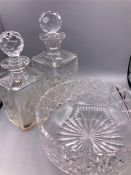 A selection of cut glass to include one bowl and two decanters