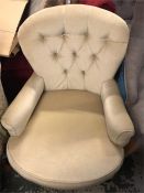 A Cream low button back chair.
