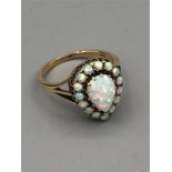 A 9ct yellow gold pear shaped opal cluster ring