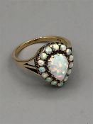 A 9ct yellow gold pear shaped opal cluster ring