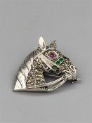 A silver and Marcasite brooch in the form of a Horse Head inset with emeralds and ruby eye