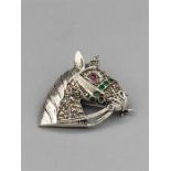 A silver and Marcasite brooch in the form of a Horse Head inset with emeralds and ruby eye