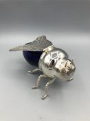 A silver plated honey pot in the shape of a bee