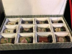 A Cloisonné collectors set by Spinks, along with display shelf