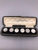 A Boxed set of mother of pearl buttons