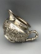 A silver milk jug