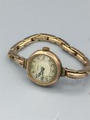 A 9ct gold Bebe watch (18.5g), strap is marked 9ct