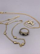 A selection of gold jewellery to include a diamond and sapphire ring, necklace with cross and a