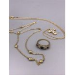 A selection of gold jewellery to include a diamond and sapphire ring, necklace with cross and a