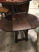 A dropsided oak oval table