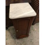 A pot cupboard with a marble top