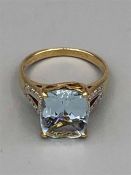 A 9ct yellow gold aquamarine and diamond dress ring