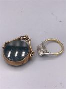 A 9ct gold ring with stone inset and a 9ct gold fob charm.